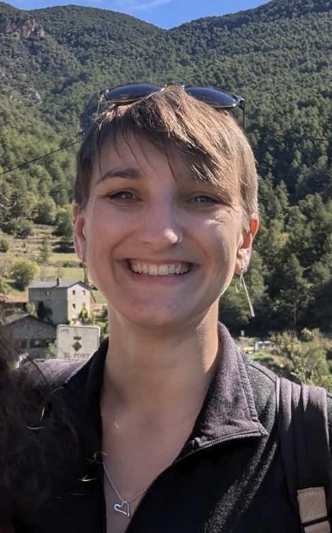 Hannah smiling in front of a forest