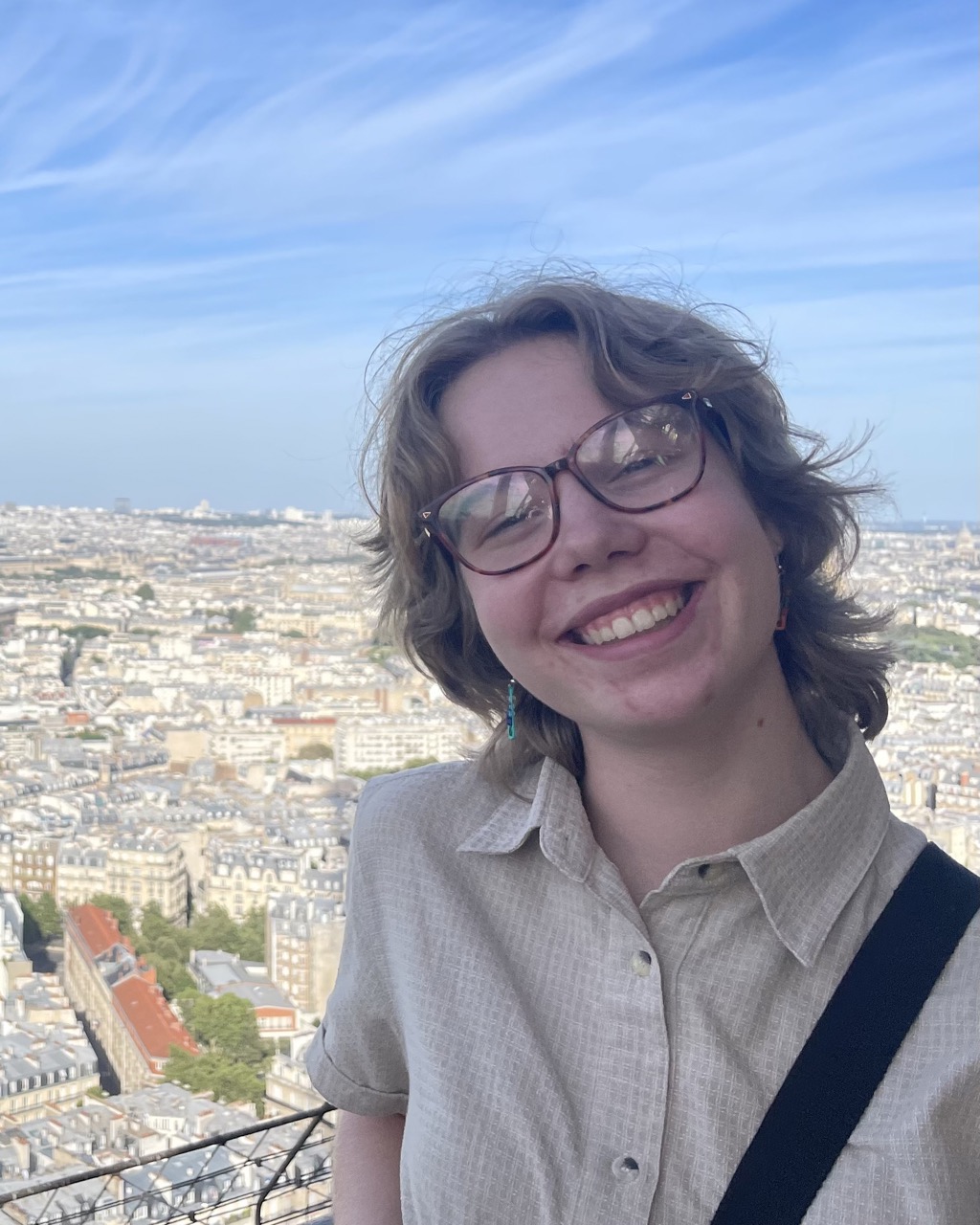 Maisie smiling in front of a city view