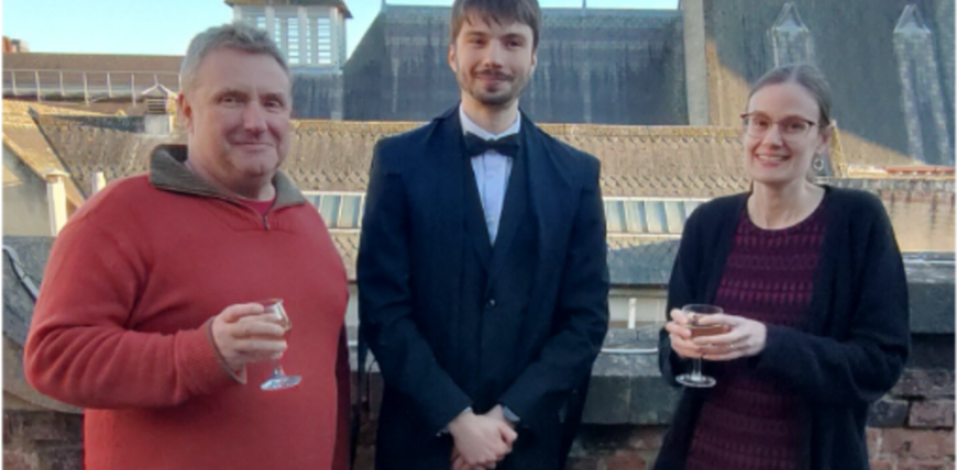 Three people smiling at the camera